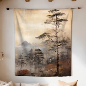 May include: A large wall tapestry featuring a serene landscape painting. The artwork depicts a misty forest scene with tall trees and a mountain range in the background. The color palette includes muted tones of beige, brown, and gray.