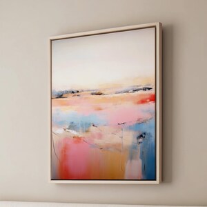 May include: Abstract landscape painting with a pink, blue, and yellow color scheme. The painting is framed in a light wood frame.