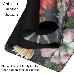 May include: A yoga mat with a floral design featuring pink, orange, and white flowers on a dark background. The mat has a black, anti-slip rubber bottom. Text on the mat reads "Anti-slip Rubber Bottom" and "The mat is kept firmly in place while you practice or exercise!"
