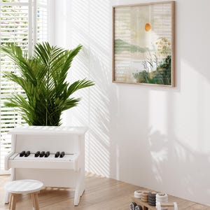 May include: A white toy piano with black keys, a white stool, and a wooden toy truck with gray and white tires. A framed print of a watercolor landscape with a sun and tall grass hangs on the wall.