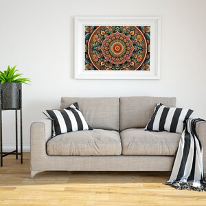 May include: A gray couch with black and white striped throw pillows and a black and white throw blanket. A white framed picture with a colorful mandala design hangs on the wall above the couch. A potted plant sits on a black metal stand to the left of the couch.