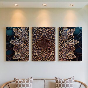 May include: Three framed wall art pieces with a dark teal and gold mandala design. The artwork is displayed on a white wall above a sofa with patterned pillows. The art has a detailed, symmetrical pattern.