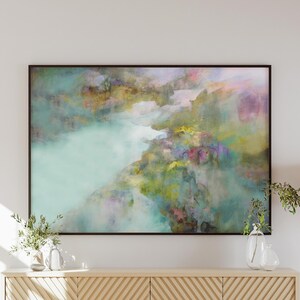 May include: Abstract painting with a blue, green, and yellow color scheme. The painting depicts a landscape with a river flowing through it. The painting is framed in a black frame.