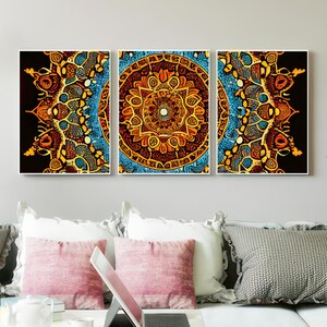 May include: A set of three ceramic mugs with a speckled, cream-colored glaze. Each mug features a different hand-painted floral design in shades of blue, green, and yellow. The mugs have a simple, rounded shape.