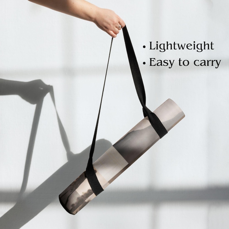 May include: Rolled yoga mat with a black carrying strap. The mat features a neutral color palette with a landscape design. Text on the image reads: Lightweight, Easy to carry.