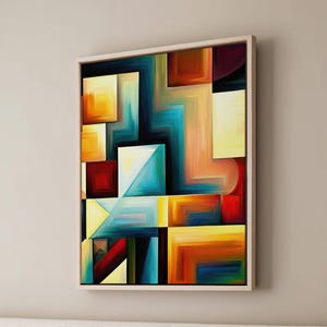 May include: Abstract painting with geometric shapes in shades of blue, yellow, orange, red, and brown. The painting is framed in a light wood frame.