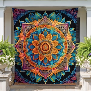 May include: A vibrant, colorful mandala flag with a detailed floral design in shades of orange, blue, and purple against a black background. The flag is displayed on a porch, adding a decorative touch to the home's exterior.