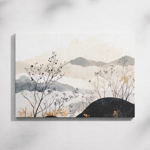 May include: Canvas art print featuring a watercolor landscape. The artwork depicts layered mountains in shades of gray and beige, with delicate black branches and foliage in the foreground. The overall aesthetic is minimalist and natural.