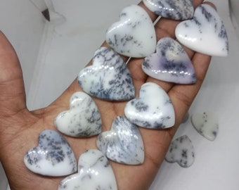 May include: A collection of white and gray heart-shaped dendritic agate stones. The stones are polished and have a smooth, shiny surface.