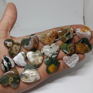 May include: A collection of 15 heart-shaped polished stones with a variety of green, brown, white, and yellow patterns.