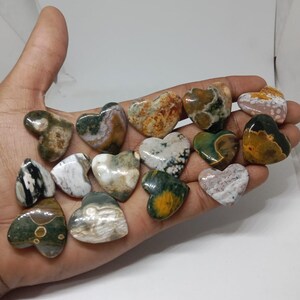 May include: A collection of 15 heart-shaped polished stones with a variety of green, brown, white, and yellow patterns.