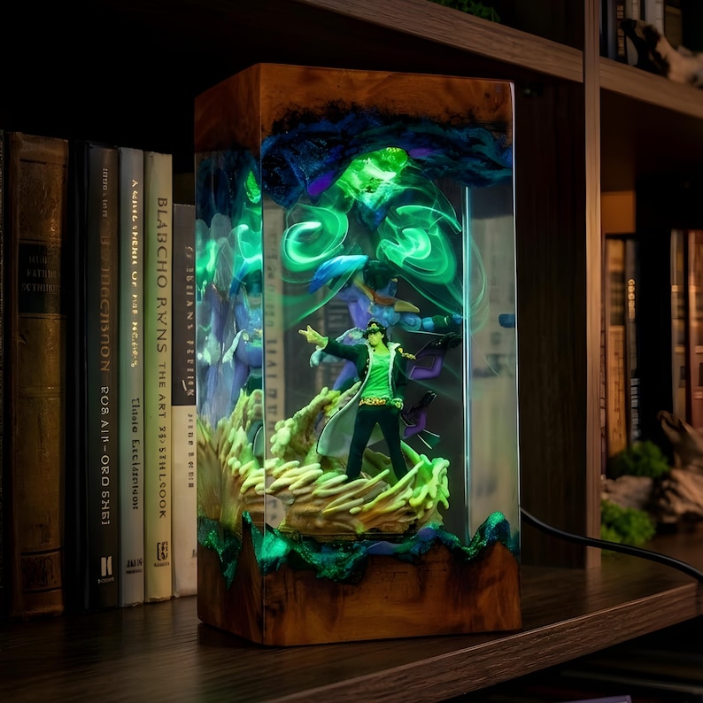 May include: A rectangular wooden lamp with a clear resin front, showcasing a figurine illuminated by green and blue lights. The lamp features a detailed figure and swirling patterns, creating a unique decorative piece.