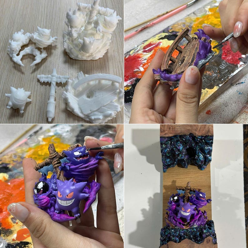 May include: A multi-part 3D printed resin kit featuring Gengar figures and a wooden cross structure. The components are shown in raw white resin, during the hand-painting process with purple and brown acrylics, and as a finished assembly.