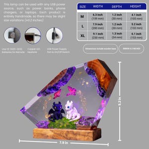 May include: A resin lamp featuring a black and white dragon figurine on a wooden base. The lamp includes purple accents, butterfly shapes, and gold flecks. A chart displays dimensions for sizes M, L, and XL, with the L size measuring 7.9 inches wide.