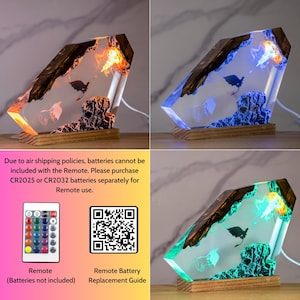 May include: A rectangular resin lamp featuring a dark wood base and embedded dragon figures. The clear resin contains textured rock-like elements and internal LED lighting that shifts between orange, blue, and green hues. Includes a remote control.