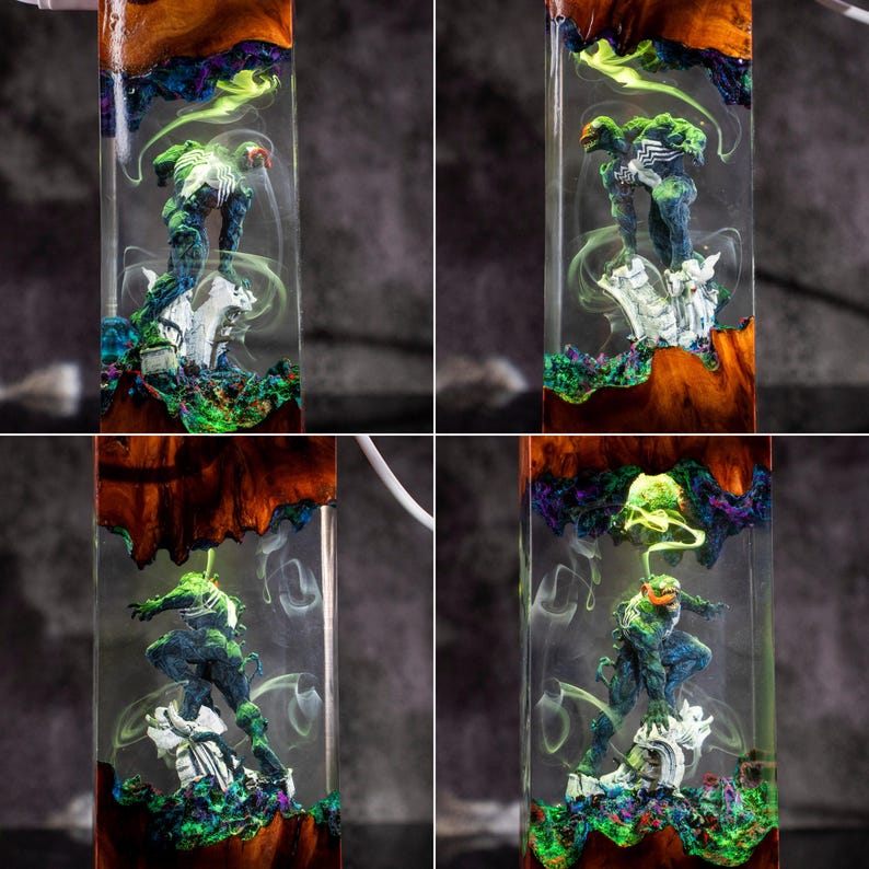 May include: Four images of a resin art piece featuring a superhero figure. The resin is clear, with a wooden base and colorful accents of green, blue, and purple. The superhero is in a dynamic pose, with a white base. The piece is encased in a rectangular shape.