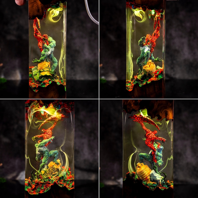 May include: A rectangular resin art piece featuring two superhero figures in a dynamic pose, encased in a clear resin block. The figures are red and green, set against a backdrop of colorful, swirling resin and wood grain.