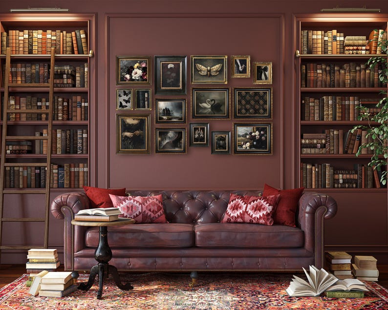 May include: A cozy library scene with a tufted leather sofa, a small round table, and a patterned rug. The walls are adorned with framed artwork and flanked by bookshelves filled with books. A wooden ladder leans against one of the shelves.