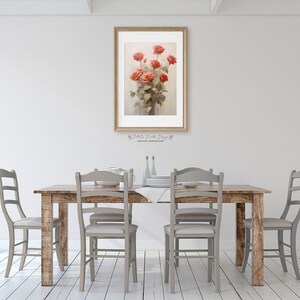 May include: A rustic wooden dining table with four gray chairs and a framed print of a bouquet of red roses hanging on the wall behind the table.