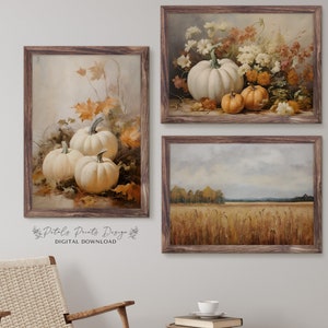 May include: Three framed prints featuring autumnal scenes. The first print shows a still life of white pumpkins and fall leaves. The second print shows a bouquet of white and orange flowers. The third print shows a field of wheat with a forest in the background.