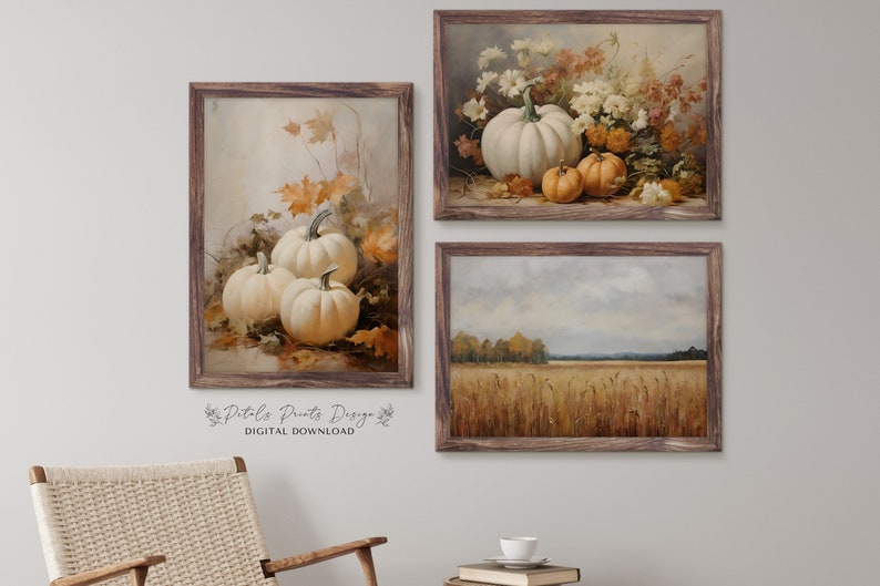 May include: Three framed prints featuring autumnal scenes. The first print shows a still life of white pumpkins and fall leaves. The second print shows a bouquet of white and orange flowers. The third print shows a field of wheat with a forest in the background.