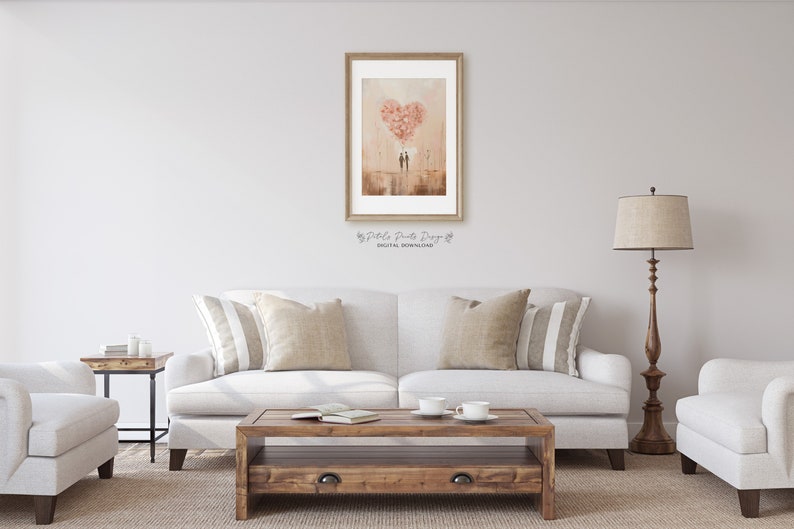 May include: A framed print of a watercolour painting depicting two figures standing beneath a large heart-shaped cloud made of pink flowers. The background is a soft, peachy colour with a hint of brown.