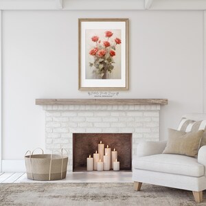 May include: A white brick fireplace with a wooden mantel and a framed print of a bouquet of red roses. The fireplace has a brown hearth and five white candles are lit in front of it. A white armchair with a beige pillow and a striped throw sits in front of the fireplace. A woven basket sits on the floor to the left of the fireplace.