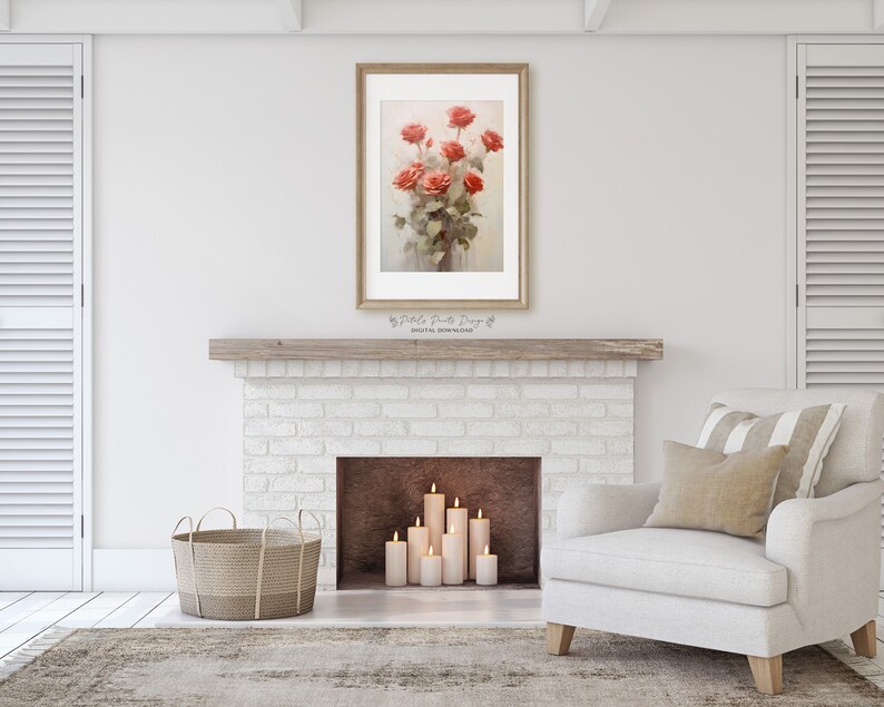 May include: A white brick fireplace with a wooden mantel and a framed print of a bouquet of red roses. The fireplace has a brown hearth and five white candles are lit in front of it. A white armchair with a beige pillow and a striped throw sits in front of the fireplace. A woven basket sits on the floor to the left of the fireplace.