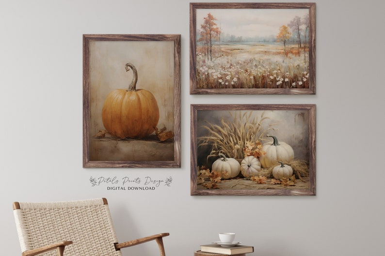 May include: Set of three fall-themed printable art prints. The first print features a single orange pumpkin on a brown background. The second print shows a field of white wildflowers with a forest in the background. The third print features a group of white pumpkins with wheat stalks and fall leaves.