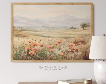 May include: A watercolor painting of a field of pink poppies in front of a mountain range. The sky is a soft blue and the mountains are a hazy purple. The painting is framed in a light wood frame.