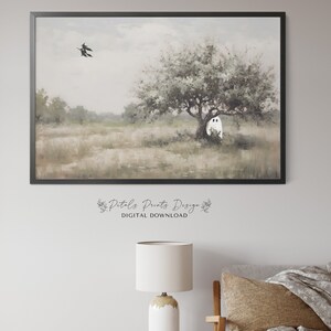 May include: A digital painting of a white ghost standing in a field under a tree. Two black witches fly in the distance. The painting has a soft, muted color palette.