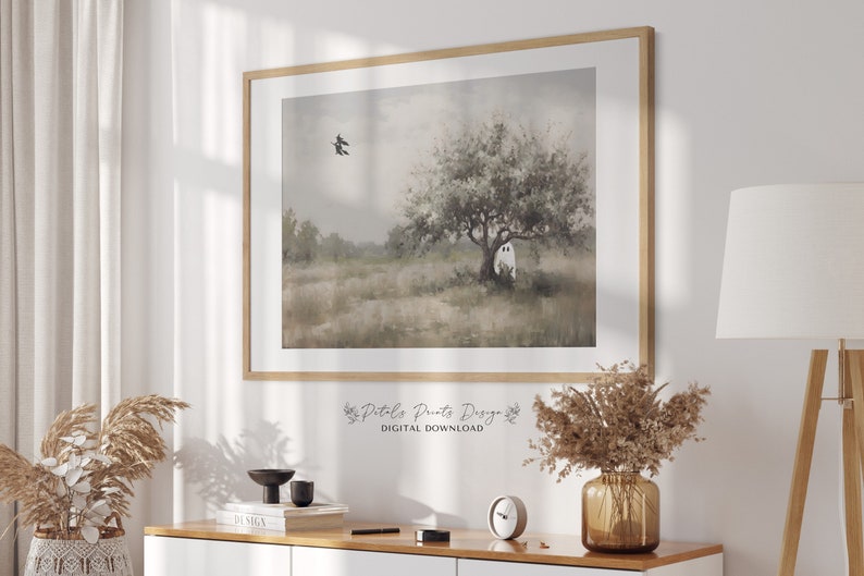 May include: A digital download of a watercolor painting featuring a white ghost in a field with a tree and a bird flying overhead. The painting has a soft, muted color palette.