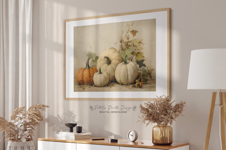 May include: A digital download print of a vintage illustration of four pumpkins, two white and two orange, with fall leaves in the background. The print has the text "Petals Prints Design" and "DIGITAL DOWNLOAD" at the bottom.