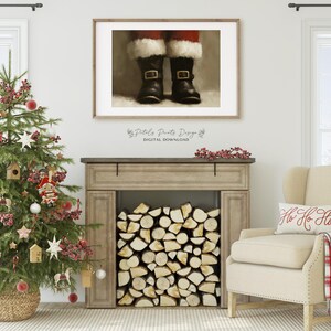May include: A digital download of a painting featuring a close-up of Santa's red boots with black buckles. The boots are on a white background with a wood-look floor. The painting is framed in a simple black frame.