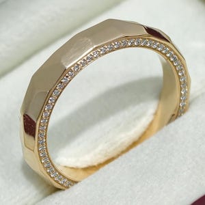 May include: A gold ring with a geometric design and a row of small, clear gemstones. The ring is set in a white jewelry box, with the Silver Salsa logo visible in the corner.