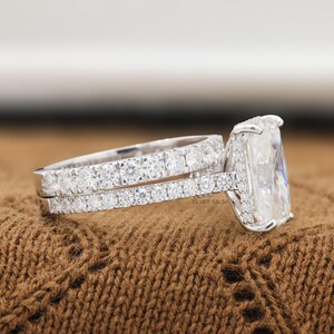 May include: A silver-toned ring set featuring a large rectangular center stone and a band encrusted with small round stones. The side of the band displays the text SILVER SALSA. The design includes a prong setting for the main stone and a pavé-style band.