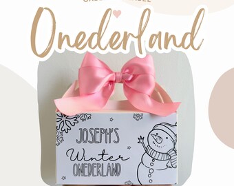 May include: A white gable box with a pink bow and a snowman design. The box has the text "Joseph's Winter Onederland" printed on it.