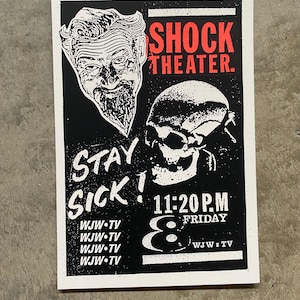 May include: A black and white poster with red text, advertising "SHOCK THEATER". The poster includes illustrations of a man's face and a skull. The words "STAY SICK!" are prominent, along with the show's time and day.