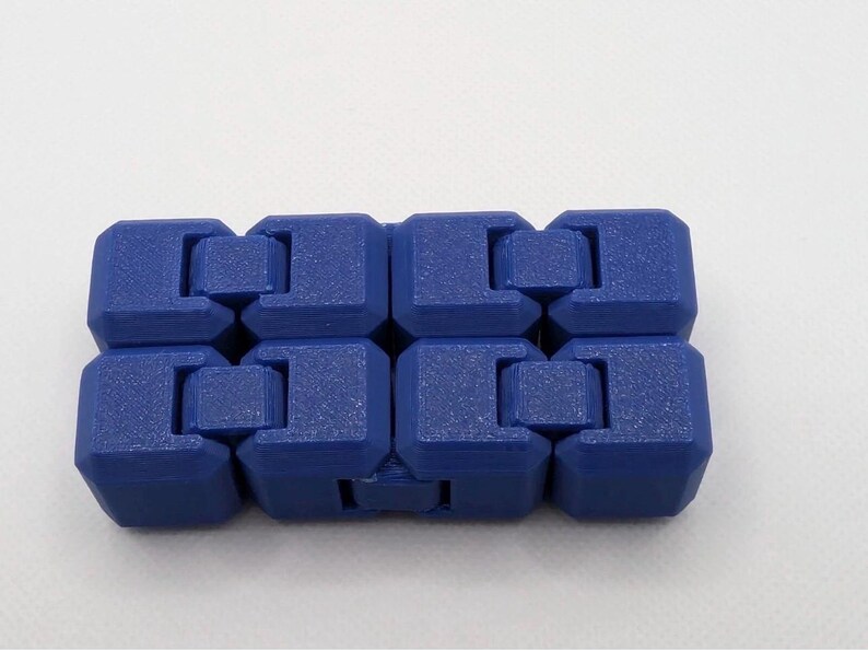 May include: A blue fidget toy composed of eight connected, cube-shaped segments. Each segment has a textured surface and is interlocked with the adjacent ones, allowing for flexible movement. The toy is designed for tactile engagement.