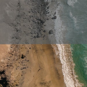 May include: Aerial view of a sandy beach with a rocky cliff on the left and turquoise ocean water on the right. The waves are crashing on the shore, creating white foam.
