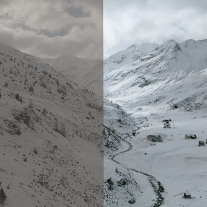 May include: A panoramic view of a snow-covered mountain range with a small village nestled in the valley. The sky is overcast with clouds.