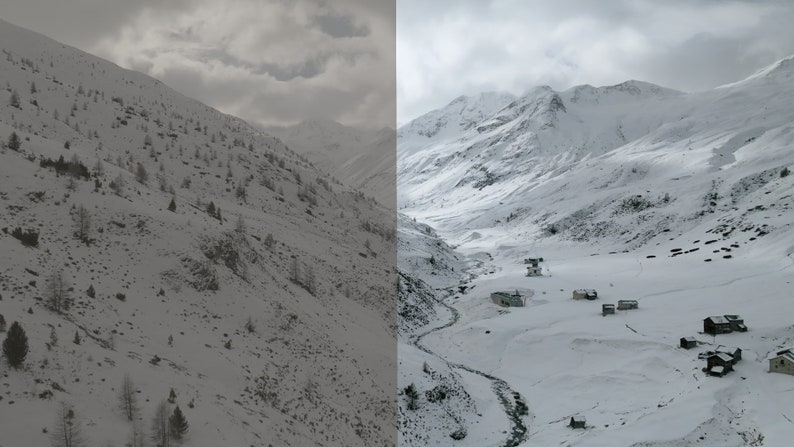 May include: A panoramic view of a snow-covered mountain range with a small village nestled in the valley. The sky is overcast with clouds.