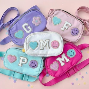 May include: A white ceramic mug with a black handle and the text "But First, Coffee" in a black, bold font. The mug is sitting on a wooden surface. The mug is approximately 4 inches tall.