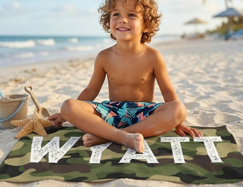 Child sitting on beach with camo name towel Wyatt, summer present boy bath wrap personalized name gift custom summer camp birthday favor pool party gift for little boy