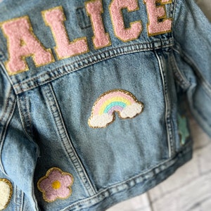 a denim jacket with patches on the back of it