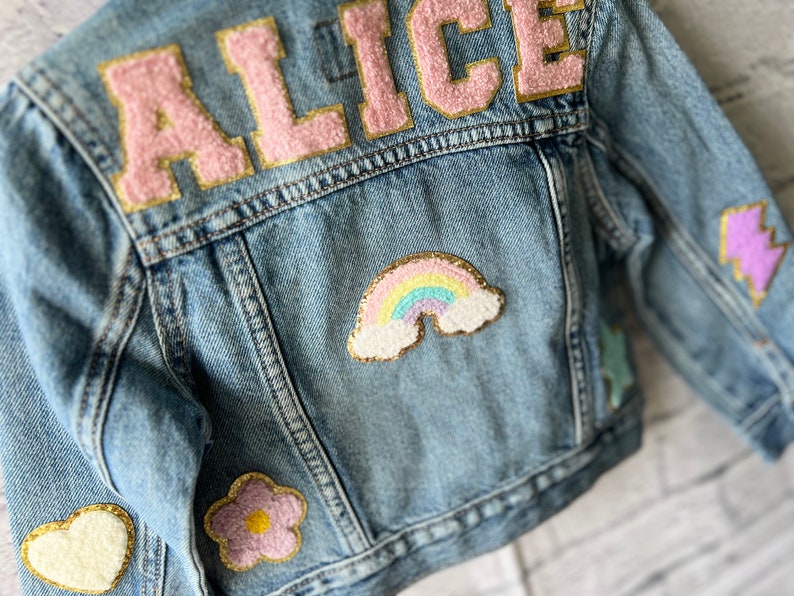 a denim jacket with patches on the back of it