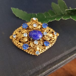 Vintage gold tone brooch, pin, adornment, filigree with two tone blue rhinestones and glass cabochon resembling lapis, sweet details