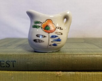 Vintage small pitcher miniature, flower decoration, made in Japan, white base with orange, blue, green, and black accents, poppy