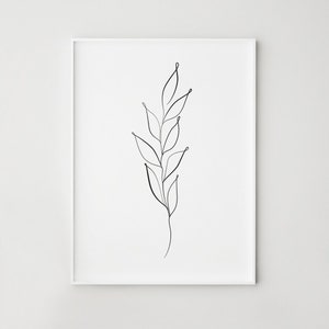 May include: A framed minimalist art print featuring a black line drawing of a plant stem with leaves. The artwork is set against a white background, creating a clean and modern aesthetic. The frame is white.