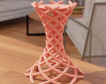 Puede incluir: Un soporte decorativo geométrico rosa con un diseño tejido. El soporte está hecho de un material ligero y tiene una base ancha.